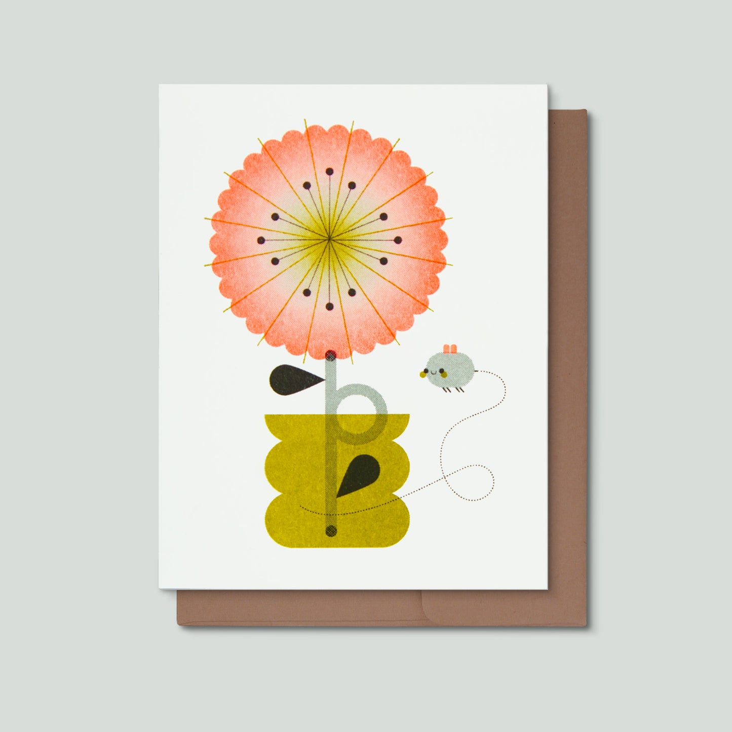 Greeting card with a colorful flower design and envelope on a light gray background