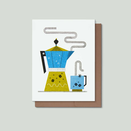 A minimalist illustrated greeting card featuring a stylized blue and yellow coffee pot and matching cup with steam lines, shown on a white card with a brown envelope against a light gray background.