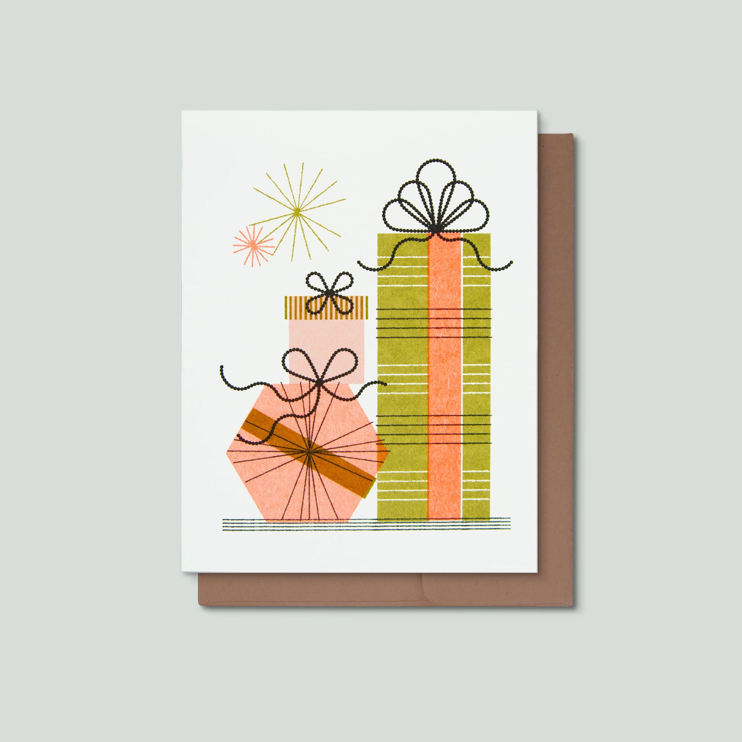 A white greeting card with a minimalist illustration of three wrapped presents, shown on top of a brown envelope against a light gray background.