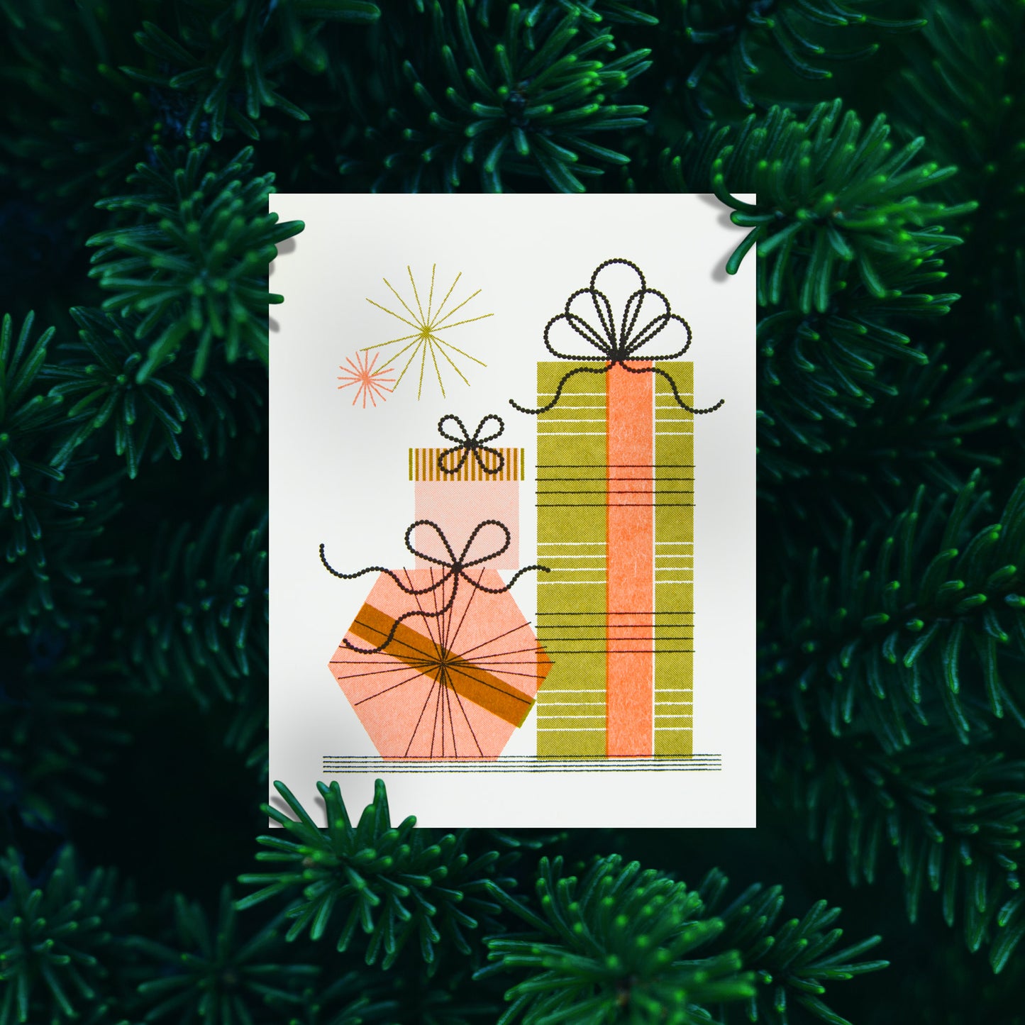 A greeting card featuring a minimalist illustration of three stacked gift boxes, set against a background of dark green pine needles.