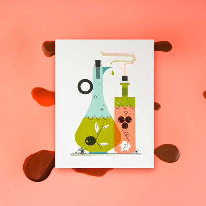 An illustrated risograph greeting card featuring a stylized illustration of oil and vinegar bottles, one light blue and one orange, with green and black details, displayed on a pink background with a splatter of balsamic vinegar.