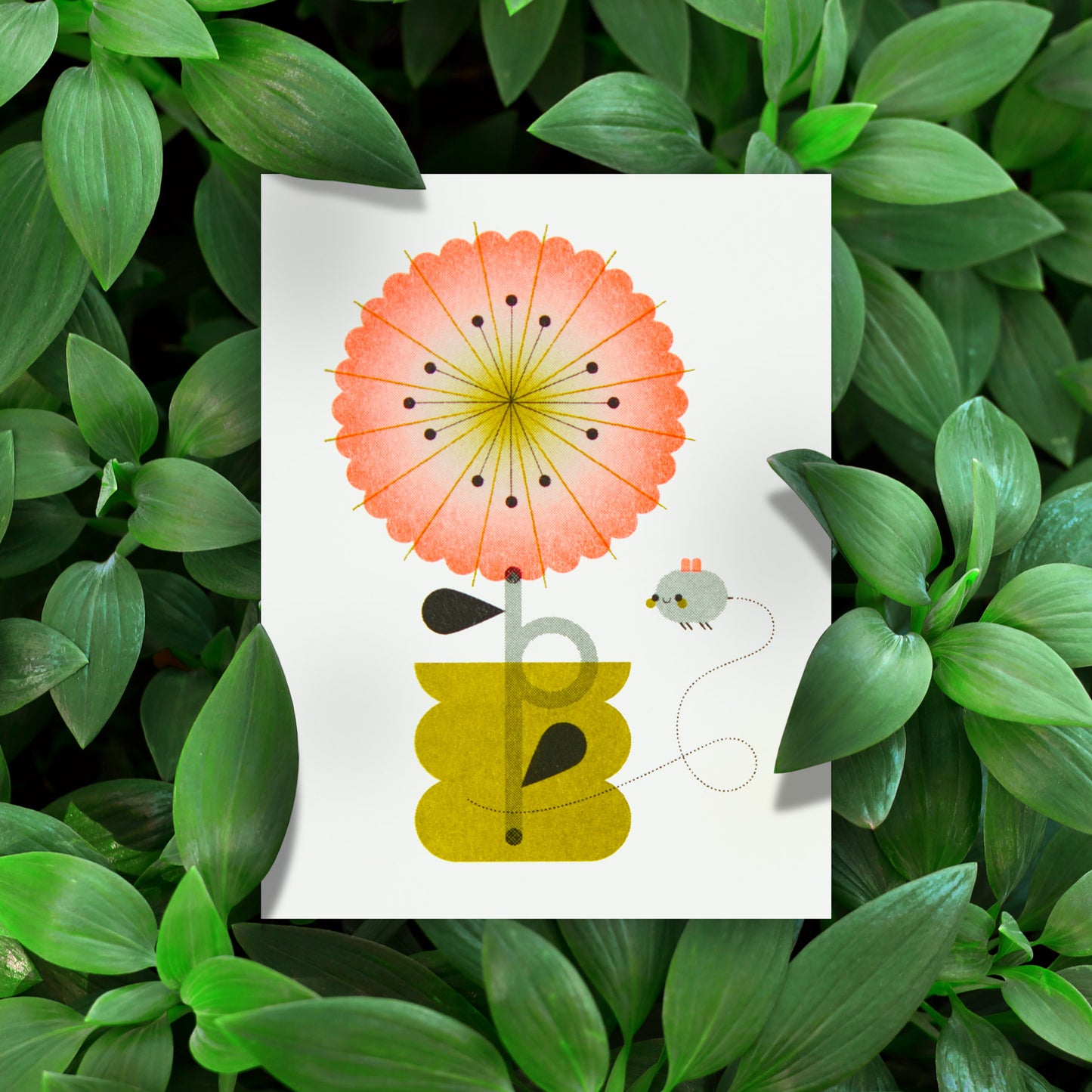 Illustration of a flower and bee on a greeting card with green leaves in the background