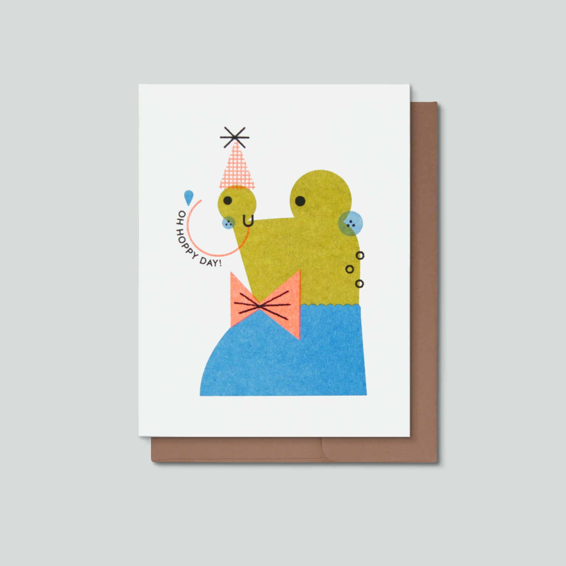 Greeting card with a colorful illustration of a frog and text that says Oh Hoppy Day on a white background