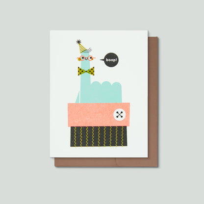 Greeting card with a smiling finger saying boop! on a gray background