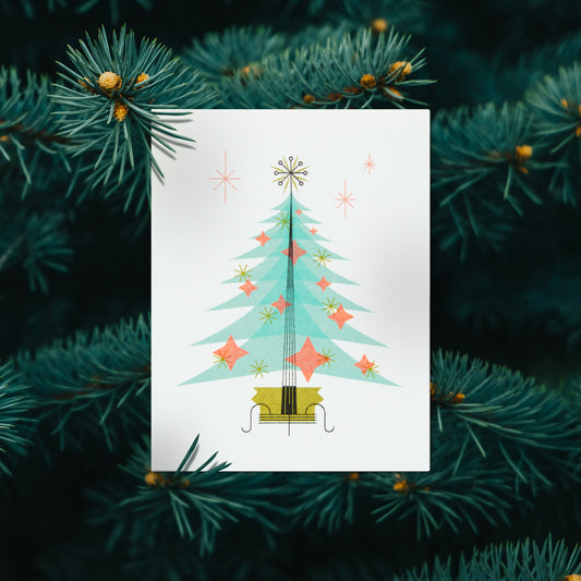 Greeting card with Christmas tree design surrounded by pine branches
