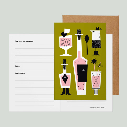 A greeting card with an illustration of cocktail bottles, glasses, and barware on an olive green background, shown with a kraft envelope and the inside of the greeting card showing recipe card lined sections on a light gray surface.