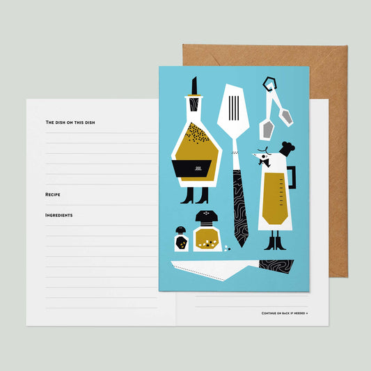A recipe card greeting card featuring a light blue front cover illustrated with stylized kitchen utensils and ingredients, shown open with lined white recipe pages and a brown kraft envelope on a pale gray background.